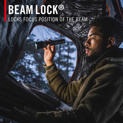 Person using Beastly Bright 4000 Lumen USB C Rechargeable LED Flashlight with Slide Focus inside tent outdoors.