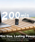 4K Mini POV Action Camera With 170 Degree Ultra Wide Lens 6 Axis Stabilization Waterproof on outdoor table next to laptop and phone.