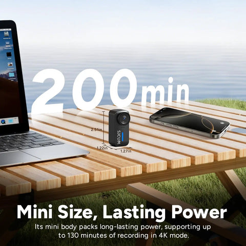 4K Mini POV Action Camera With 170 Degree Ultra Wide Lens 6 Axis Stabilization Waterproof on outdoor table next to laptop and phone.