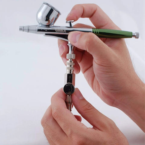 Hands holding MAC Valve With Quick Connect Coupler And Plug For Universal Airbrush Control On Any Brand Airbrush Easy Quick Swap