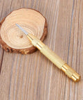 No Sweat Automatic Center Punch Four Piece Kit With Adjustable Spring Impact and High Speed Steel Nose on wood slice.