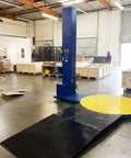 Ready To Run Automatic Stretch Wrap Machine With Loading Ramp Includes Built In Scale Weighs 5000 Pounds in warehouse setting.