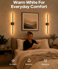 A woman reading in bed by a GOODEA Rechargeable RGB Wall Sconce with 2 Replaceable Batteries providing warm white light.