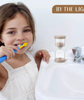 Child brushing teeth with Nine Colorful Luminous Sand Timers Set With 0.5, 1, 2, 3, 5, 10, 15, 20, 30 Minute Intervals Glow In The Dark.