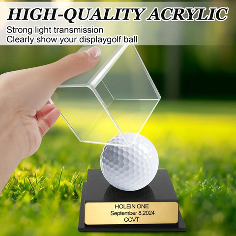 Hand holding acrylic Hole In One Golf Display Case With Acrylic Ball Holder And Custom Engraved Plaque, grassy background