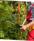 Person using Extended Wand Sprayer Handle Replacement For Garden And Home Use Compatible With Backpack Sprayers on plants
