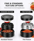 Two 3-inch spice grinders with dual grind plates for fine and standard texture; black plastic and silver stainless top.