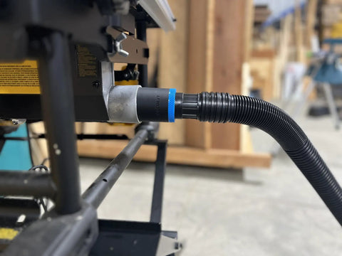 Close-up of a One Seven Eight Inch Hose Adapter For Two And One Quarter Inch Table Saw Dust Ports With Quick Twist Lock compatible with Dewalt Milwaukee and Ridgid saws installed on a table saw.