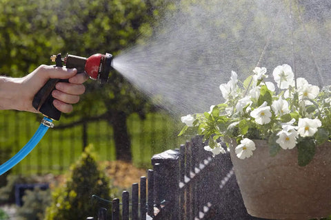 Solid Brass Garden Hose Repair Kit With 1/2 Inch Connectors watering potted flowers with spray nozzle