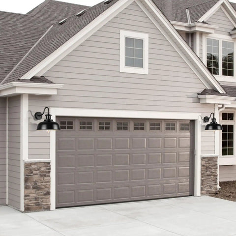 Front view of a garage with two black Solar Barn Light For Outdoor Use Dusk To Dawn Outdoor Wall Sconce With Solar Power No Wiring Hassle Rustic Industrial Exterior Lighting For Garage Shed Farmhouse Look installed beside the door.