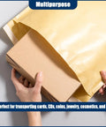 Hand placing box inside 25 Pack Kraft Bubble Mailers 9.5x13.5 Inch Large Padded Self Seal Shipping Envelopes Tear Resistant And Eco Friendly