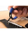 Premium Acoustic Guitar Bridge Pin Puller in use, rubber exterior, one-handed grip, lifting bridge pins safely and smoothly.