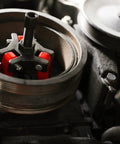 Harmonic Balancer Puller Kit for cars and trucks with adjustable 3-jaw design in use inside a tight engine compartment