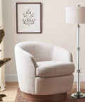60 Inch Polished Nickel And Clear Glass Floor Lamp With White Linen Round Shade next to living room chair and artwork