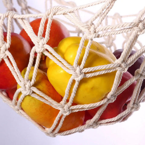 Hand-Woven Cotton Fruit Hammock With Hooks For Under-Cabinet Kitchen Storage holding colorful produce in a close-up view