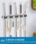 2 Pack Stainless Steel Wall Mount Broom Holder With 5 Racks And 4 Hooks Heavy Duty Self Adhesive Broom Organizer installed on wall