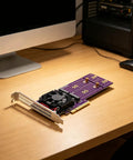 Kickstart Desktop Upgrade With This Dual Bay M.2 NVMe Enclosure Feature PCI Express 4.0 Riser Card on a wooden desk.