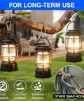 Carabiner clips securing three black lanterns hanging from a branch
