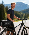 Cyclist on road with 13L Expandable Bike Rack Bag With Rain Cover Rear Trunk Pannier For E Bikes And City Rides attached to rear rack.