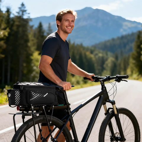 Cyclist on road with 13L Expandable Bike Rack Bag With Rain Cover Rear Trunk Pannier For E Bikes And City Rides attached to rear rack.