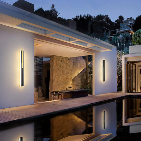 Outdoor LED Wall Light 31.5 Inch Black Sconce With Rectangular Acrylic Panel illuminating a modern patio exterior at night.