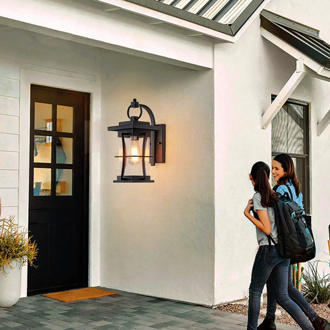 Matte Black Outdoor Wall Light Fixture For Patio And Front Porch Built To Last, illuminating entrance with visitors approaching.