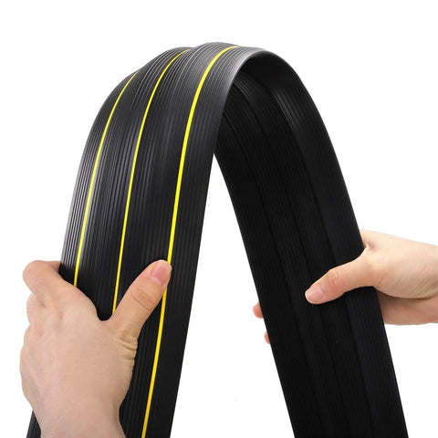 Hands holding a 10 Foot Floor Cord Cover with large cable channels, showing heavy duty PVC material for easy organization and trip hazard prevention.