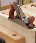 Top Notch Number Three Smoothing Plane For Fine Woodworking Trims on a wood surface, showcasing a cast iron base and hardwood handles.