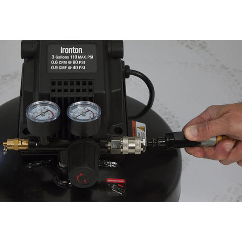Close-up of Portable 3 Gallon Air Compressor 0.3 HP 110 PSI Max Pressure Oil Free Pump with gauges and hose connection.