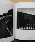 Open book showing moody black and white night urban scenes, from Moody Black And White Night Photography Book Featuring Night Walk By Michael Kenna With 40 Full Page Plates And A 59 Page Softcover Look At Quiet Urban And Rural Nightscapes For Collectors Of Classic Night Imagery.
