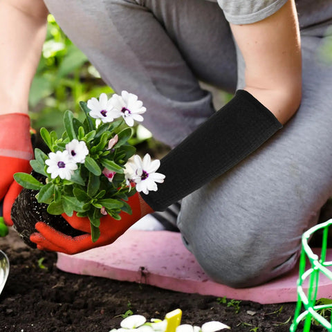 Dang Tough Cut Resistant Arm Sleeves For Gardeners And Carpenters With Elastic Wrist Guard Heat Resistant Safety Gear protecting forearm while planting flowers.