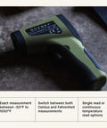 Infrared Thermometer With Built In Laser For Precise Temperature Readings, LED Display, Non Contact Measurement, Wireless Convenience, 9V Battery Included, Great For Pizza Ovens, Grills, And Home Kitchens. Green handheld infrared thermometer on countertop.