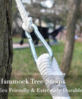 Tree Swing Straps And Hammock Rope Kit, 13 Ft Each With Heavy Duty Carabiner Hooks in use outdoors on tree trunk.