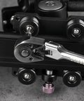 Close-up of Four Piece Inch Drive Ratchet Set With Flexible Head And Quick Release The Go To Beast Tool for Tight Spaces in use on machinery.
