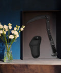 Folding Sickle Garden Tool With Wooden Handle And Sheath Portable Sharp Grass Cutter displayed on shelf with flowers