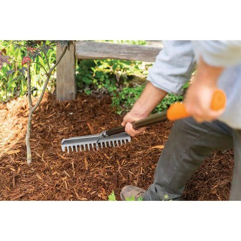 Gardener using 60 Inch Pro Garden Rake With Lightweight Aluminum Handle For Soil A Heavy Duty Gardening Tool For Spreading Mulch Dirt And Gravel Welded Head With Hardened Tines For Maximum Power And Precision In The Yard on mulch