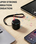 Ultra Tiny Bluetooth Speaker With HD Sound And Deep Bass Mini Wireless Speaker for Phone PC and Tablet on desk with laptops