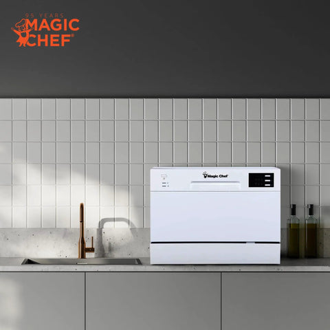 Real Deal Compact Countertop Dishwasher For Modern Kitchens Clean Cycle For Six Place Settings With A Durable Stainless Steel Tub And Super Chill Quiet Operation No Sweat Push Button Controls Space Savvy Portable Mini Washing Machine In Fresh White placed on a kitchen counter.