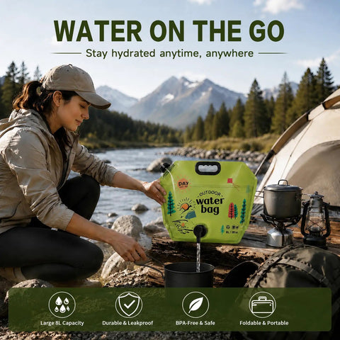 Woman using 2 Gallon Collapsible Camping Water Container With Spout by river, tent and stove visible