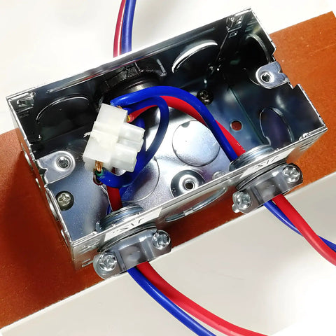 Rock Solid 12 Piece One Half Inch Clamp Cable Connectors No Sweat Zinc Alloy Quick Install Zero Drama Heavy Duty Electrical Wire Joiners installed in metal electrical box with red and blue wires.