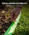 Hose being staked into the ground, showcasing Flat Soaker Hose With Stakes 50Ft Watering Made Easy For Garden And Lawn Yard Irrigation.