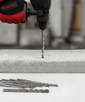 Front view: WORKPRO 8-piece SDS-Plus drill bit set with carbide tips; bits shown alongside a concrete block.