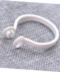 Close-up of a white plastic circular curtain ring from 60 Pack Plastic Circular Curtain Rings For Rods With Smooth Glide No Burr.