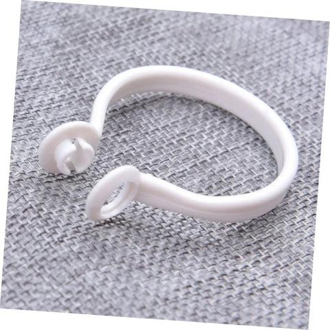 Close-up of a white plastic circular curtain ring from 60 Pack Plastic Circular Curtain Rings For Rods With Smooth Glide No Burr.