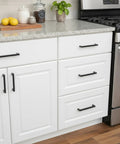 Kitchen cabinets with 10 Pack Matte Black Cabinet Handles Stainless Steel Drawer Pulls, installed on white cupboards, 7-inch hole centers.