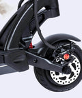 Rear view of HB-100 Hydraulic Disc Brake Caliper Kit on electric scooter, showing black caliper, brake disc, and wheel