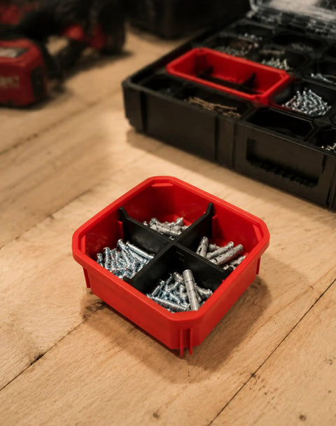 Packout Compatible Cross Divider Insert for Slim Bins containing screws on wooden surface.