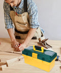 Heavy Duty Portable Plastic Toolbox With Secure Locking Latch And Multi Compartment Storage on a workbench with tools.