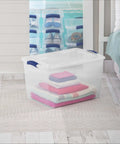 Heavy Duty SixtySix Quart Clear Plastic Storage Bins Two Pack With Blue Latch Lids Stackable Organizers for blankets in bedroom.