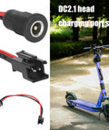 Beefy 5.5x2.1mm Power Socket for Scooters with cable and plastomer sleeve next to an electric scooter on a park path.
